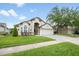Charming one-story home featuring a manicured lawn and lovely landscaping at 525 Hardwood Cir, Orlando, FL 32828