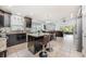 Open kitchen flowing into a dining and living area, featuring an island with bar stools at 525 Hardwood Cir, Orlando, FL 32828