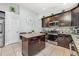 Kitchen features stainless steel appliances, granite countertops and island seating at 525 Hardwood Cir, Orlando, FL 32828