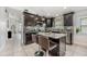 Spacious kitchen with dark wood cabinets, granite countertops, and a center island at 525 Hardwood Cir, Orlando, FL 32828