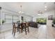 Living room view featuring tile floors, an adjacent dining area, and outside access at 525 Hardwood Cir, Orlando, FL 32828