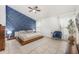 Stylish main bedroom with a blue accent wall, platform bed, and elegant decor at 525 Hardwood Cir, Orlando, FL 32828