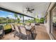 Covered patio with outdoor dining and entertaining space overlooking the lake at 525 Hardwood Cir, Orlando, FL 32828