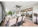 This screened patio has a dining table, ceiling fans, and sliding glass doors at 525 Hardwood Cir, Orlando, FL 32828