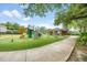 Community playground with a slide, climbing wall, swing set, and picnic shelter at 525 Hardwood Cir, Orlando, FL 32828