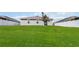 Large backyard with a new tree, lush green lawn, and partial fencing, ready for outdoor activities at 5347 Travertine St, Mount Dora, FL 32757