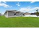 Spacious backyard with lush lawn, rear patio, and privacy fencing at 5347 Travertine St, Mount Dora, FL 32757