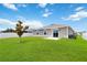 Well-maintained backyard with green lawn, rear patio, and privacy fence at 5347 Travertine St, Mount Dora, FL 32757