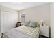 A bright bedroom offers a comfortable bed, neutral walls, plush carpeting and a double closet for storage at 5347 Travertine St, Mount Dora, FL 32757