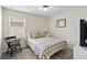 This charming bedroom features a cozy queen bed, natural light from the window and a comfortable chair at 5347 Travertine St, Mount Dora, FL 32757