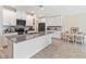 Bright kitchen with white cabinets, gray countertops, stainless appliances, and a dining area at 5347 Travertine St, Mount Dora, FL 32757