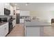 Modern kitchen featuring white cabinets, stainless steel appliances, and a large center island at 5347 Travertine St, Mount Dora, FL 32757