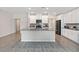 Bright, open kitchen with island, stainless steel appliances, and white cabinets at 5347 Travertine St, Mount Dora, FL 32757