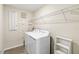 Functional laundry room with a white washer and dryer, shelving, and neutral decor at 5347 Travertine St, Mount Dora, FL 32757