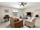 Cozy living room with a sliding door, ceiling fan, and view of the outdoors at 5347 Travertine St, Mount Dora, FL 32757