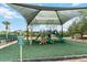 Community playground with a sunshade and safety surfacing for children ages 5-12 at 5347 Travertine St, Mount Dora, FL 32757