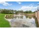 Community entrance featuring a landscaped pond with a water fountain and community signage at 5347 Travertine St, Mount Dora, FL 32757
