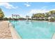 Expansive community pool with brick trim and multiple seating areas for residents and guests at 5347 Travertine St, Mount Dora, FL 32757
