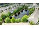 A tranquil aerial view shows a community with a pond and fountain at 561 Pinebranch Cir, Winter Springs, FL 32708