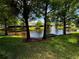 Scenic backyard view overlooking the pond with a fountain feature at 561 Pinebranch Cir, Winter Springs, FL 32708