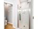 Modern bathroom with glass enclosed shower and white marble tile at 561 Pinebranch Cir, Winter Springs, FL 32708