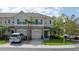 Charming townhouse showcasing a well-maintained lawn and neatly paved driveway, adding to its curb appeal at 561 Pinebranch Cir, Winter Springs, FL 32708