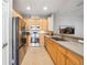 Modern kitchen featuring stainless steel appliances and natural wood cabinets, perfect for home cooking at 561 Pinebranch Cir, Winter Springs, FL 32708