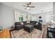 Comfortable living room features a large sectional couch, stylish area rug, and bright natural light from windows at 561 Pinebranch Cir, Winter Springs, FL 32708