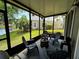 Comfortable screened patio with outdoor seating and tranquil water views at 561 Pinebranch Cir, Winter Springs, FL 32708