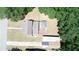 A bird's-eye view showcases the home's layout with a deck, lush surroundings, and convenient driveway at 613 Michigan Ave, St Cloud, FL 34769