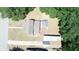 A bird's-eye view showcases the home's layout with a deck, lush surroundings, and convenient driveway at 613 Michigan Ave, St Cloud, FL 34769