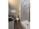 Modern bathroom featuring tiled shower with new fixtures, granite countertop, and updated vanity at 613 Michigan Ave, St Cloud, FL 34769