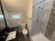 Modern bathroom featuring tiled shower with new fixtures, granite countertop, and updated vanity at 613 Michigan Ave, St Cloud, FL 34769