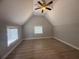 Bright bedroom featuring hardwood floors, a ceiling fan, and natural light from multiple windows at 613 Michigan Ave, St Cloud, FL 34769