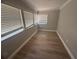 Bedroom with sleek floor, neutral paint, and natural light from three windows at 613 Michigan Ave, St Cloud, FL 34769