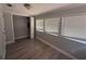 Bedroom with sleek floor, neutral paint, closet, and natural light from three windows at 613 Michigan Ave, St Cloud, FL 34769