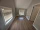 Bedroom with two windows, new floors and light grey paint at 613 Michigan Ave, St Cloud, FL 34769