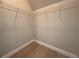 Walk-in closet with wire shelving and modern wood-look laminate flooring at 613 Michigan Ave, St Cloud, FL 34769