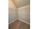 Walk-in closet with wire shelving and modern wood-look laminate flooring at 613 Michigan Ave, St Cloud, FL 34769