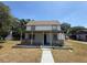 Charming two-story home with a cozy covered front porch and well-maintained landscaping enhances curb appeal at 613 Michigan Ave, St Cloud, FL 34769