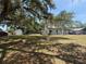 Charming two-story home featuring a lush front yard with mature trees, and inviting curb appeal at 613 Michigan Ave, St Cloud, FL 34769