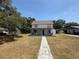 Charming two-story home with a cozy covered front porch, stone walkway, and well-maintained lawn at 613 Michigan Ave, St Cloud, FL 34769