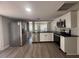 Modern kitchen with stainless steel appliances, white cabinetry and light backsplash at 613 Michigan Ave, St Cloud, FL 34769