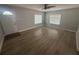 Bright living room features sleek floors, neutral paint, and natural light from two windows at 613 Michigan Ave, St Cloud, FL 34769