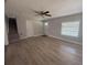 Bright living room features sleek floors, neutral paint, and stairs to upper level at 613 Michigan Ave, St Cloud, FL 34769
