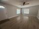 Bright living room features sleek floors, neutral paint, and natural light from two windows at 613 Michigan Ave, St Cloud, FL 34769