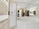 Bathroom boasts a vanity with white cabinets, a shower, and a corner bathtub at 688 W Cranes Cir, Altamonte Springs, FL 32701