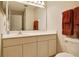 Bathroom boasts a vanity with white cabinets, a large mirror, and orange towels at 688 W Cranes Cir, Altamonte Springs, FL 32701