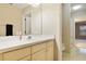 Bathroom with white sink, large mirror, tan vanity and shower in separate room at 688 W Cranes Cir, Altamonte Springs, FL 32701