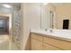 This bathroom features a shower and single sink with a vanity and large mirror at 688 W Cranes Cir, Altamonte Springs, FL 32701